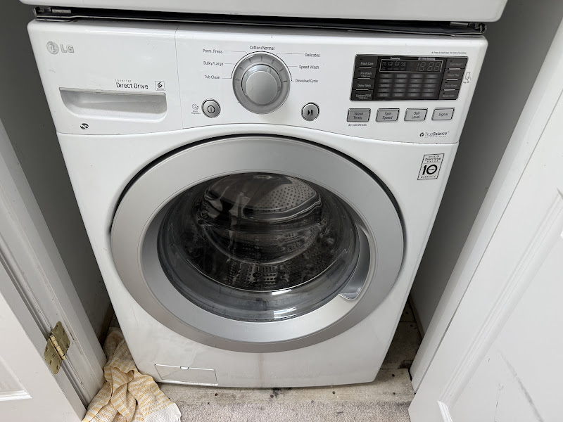 LG front-load washing machine repair by Appliance Solutions technician in customer home