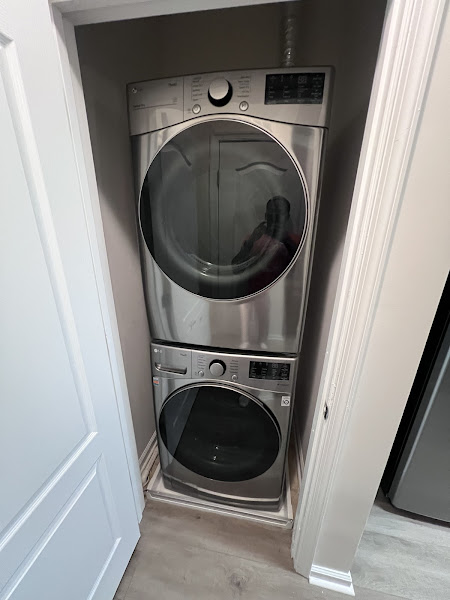 Stacked LG washer and dryer unit installed by Appliance Solutions in Northern Virginia laundry closet